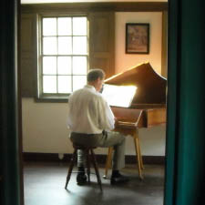 Richard Spicer at the harpsichord in Pitt Tavern at Strawbery Banke Museum.
