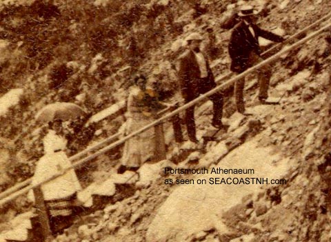 Tourists climb wooden stairway